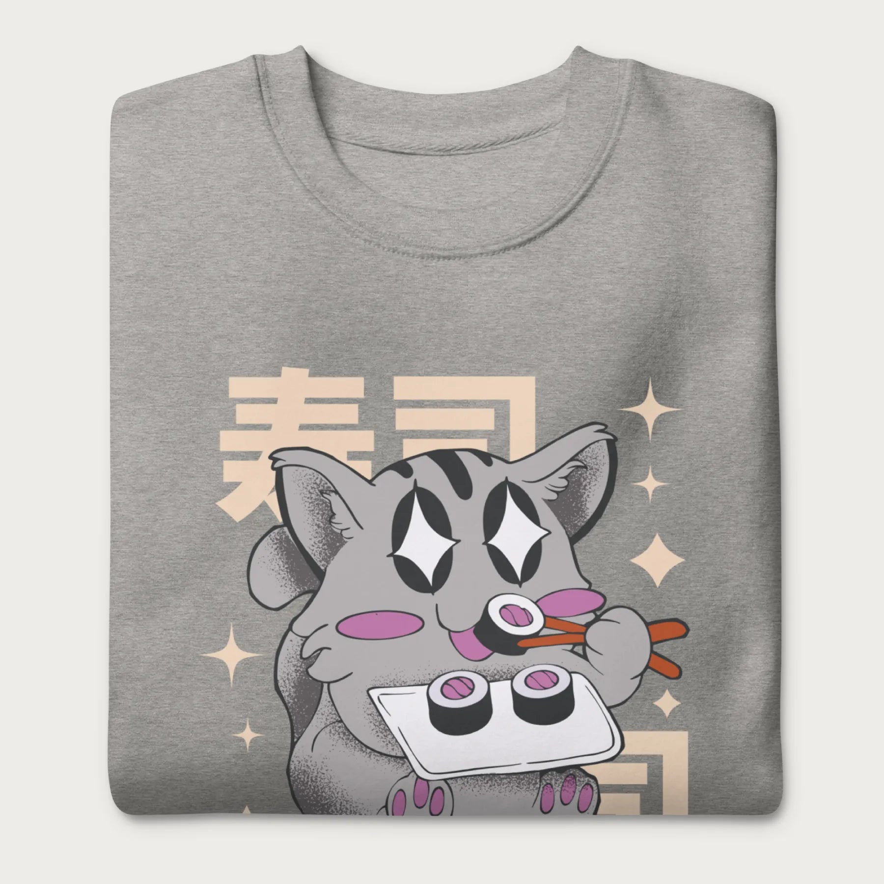 Folded light grey sweatshirt with Japanese text and a kawaii graphic of a cat eating sushi.