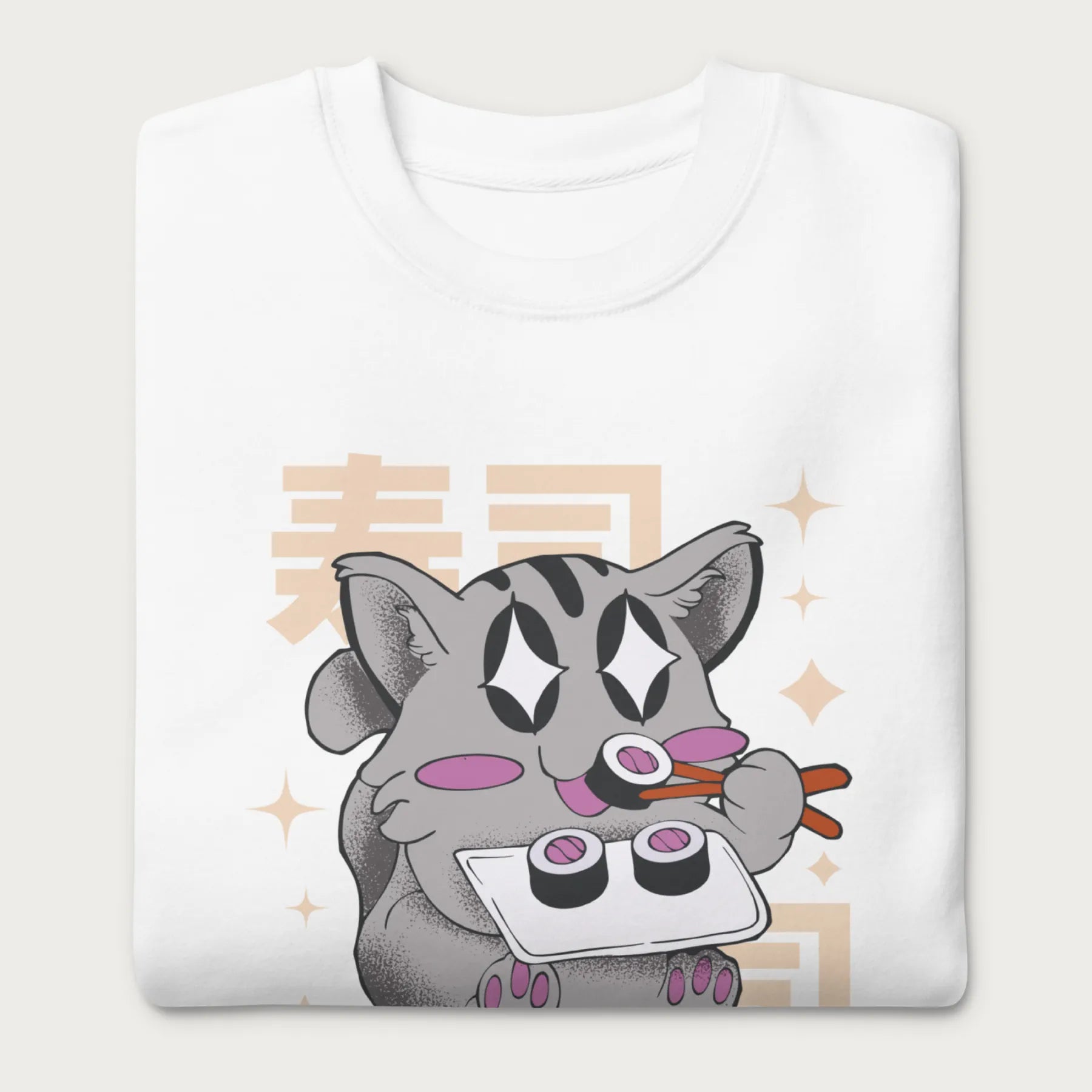 Folded white sweatshirt with Japanese text and a kawaii graphic of a cat eating sushi.