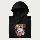 Folded black hoodie with Japanese graphic of a sushi monster over a burning city with Japanese text.