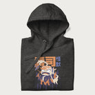 Folded dark grey hoodie with Japanese graphic of a sushi monster over a burning city with Japanese text.