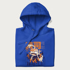 Folded royal blue hoodie with Japanese graphic of a sushi monster over a burning city with Japanese text.