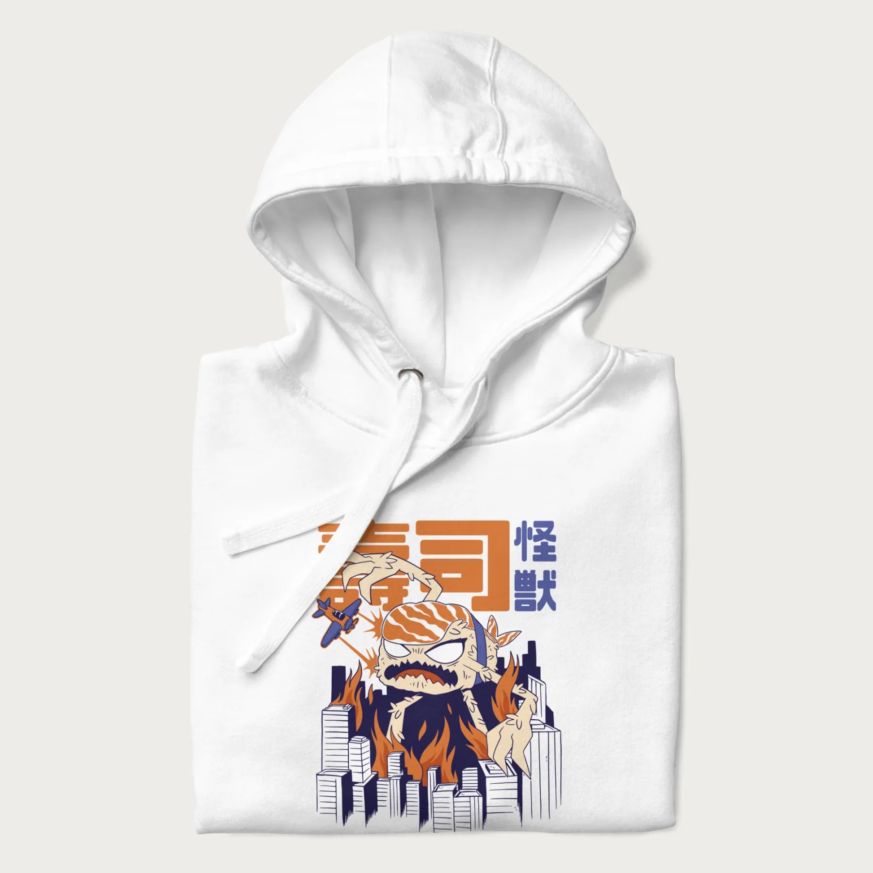 Folded white hoodie with Japanese graphic of a sushi monster over a burning city with Japanese text.