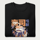 Folded black sweatshirt with a graphic of a monstrous sushi roll attacking a city and Japanese text.