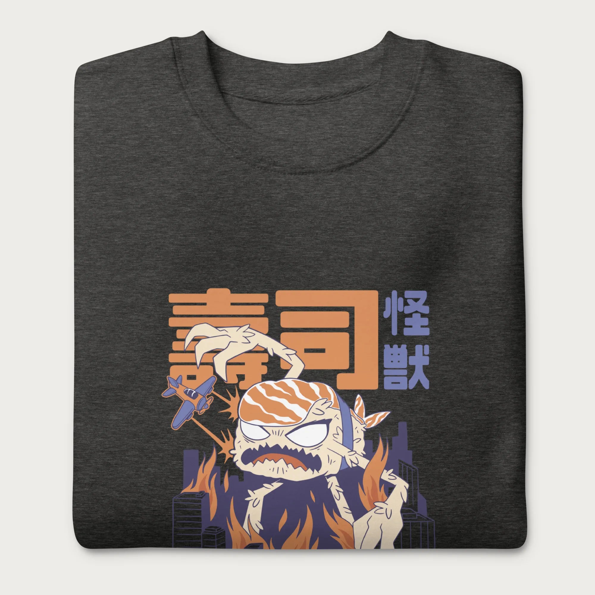 Folded dark grey sweatshirt with a graphic of a monstrous sushi roll attacking a city and Japanese text.