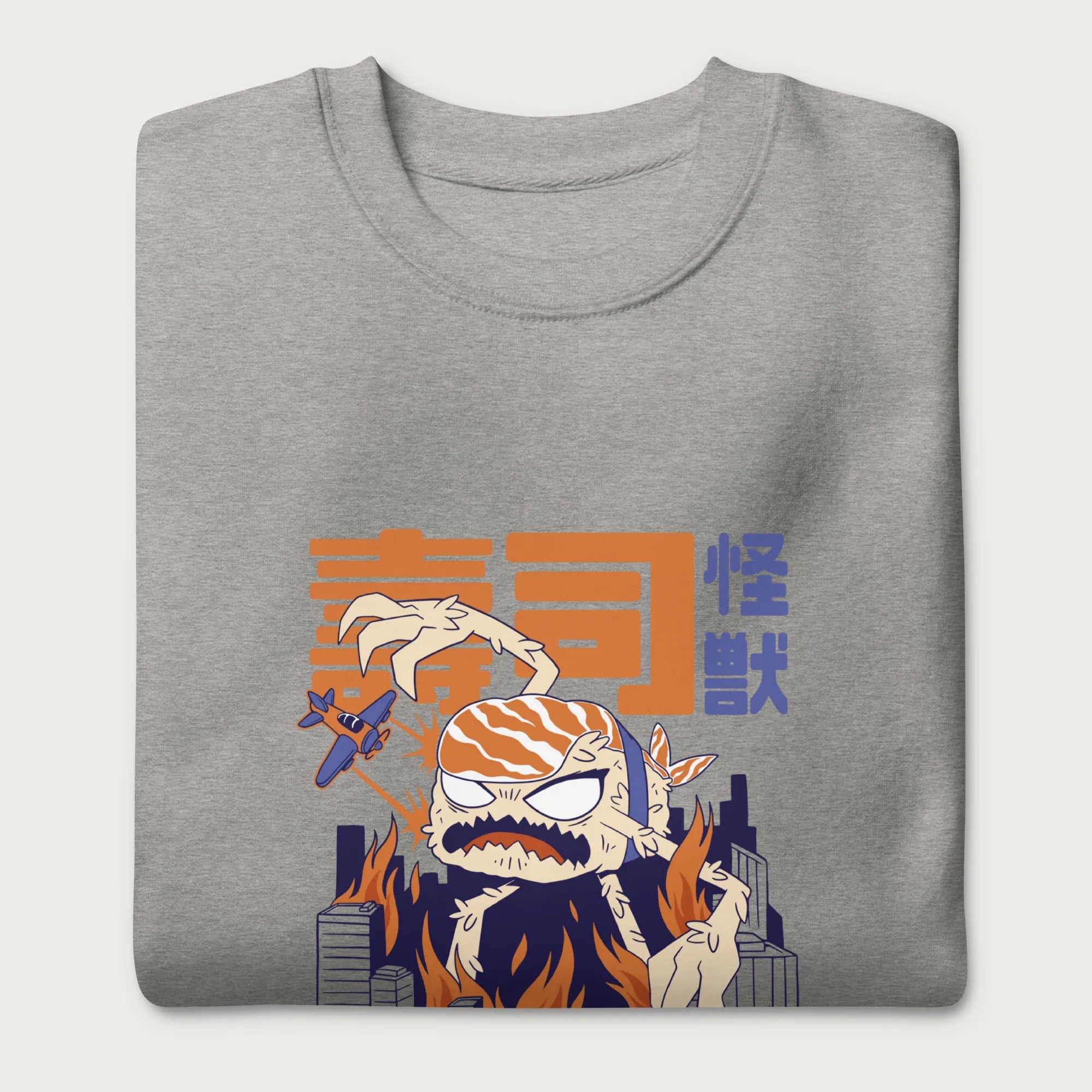 Folded light grey sweatshirt with a graphic of a monstrous sushi roll attacking a city and Japanese text.