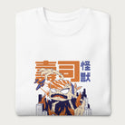 Folded white sweatshirt with a graphic of a monstrous sushi roll attacking a city and Japanese text.