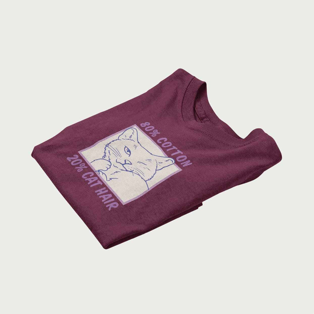 Neatly folded t-shirt with graphic of a cat winking.