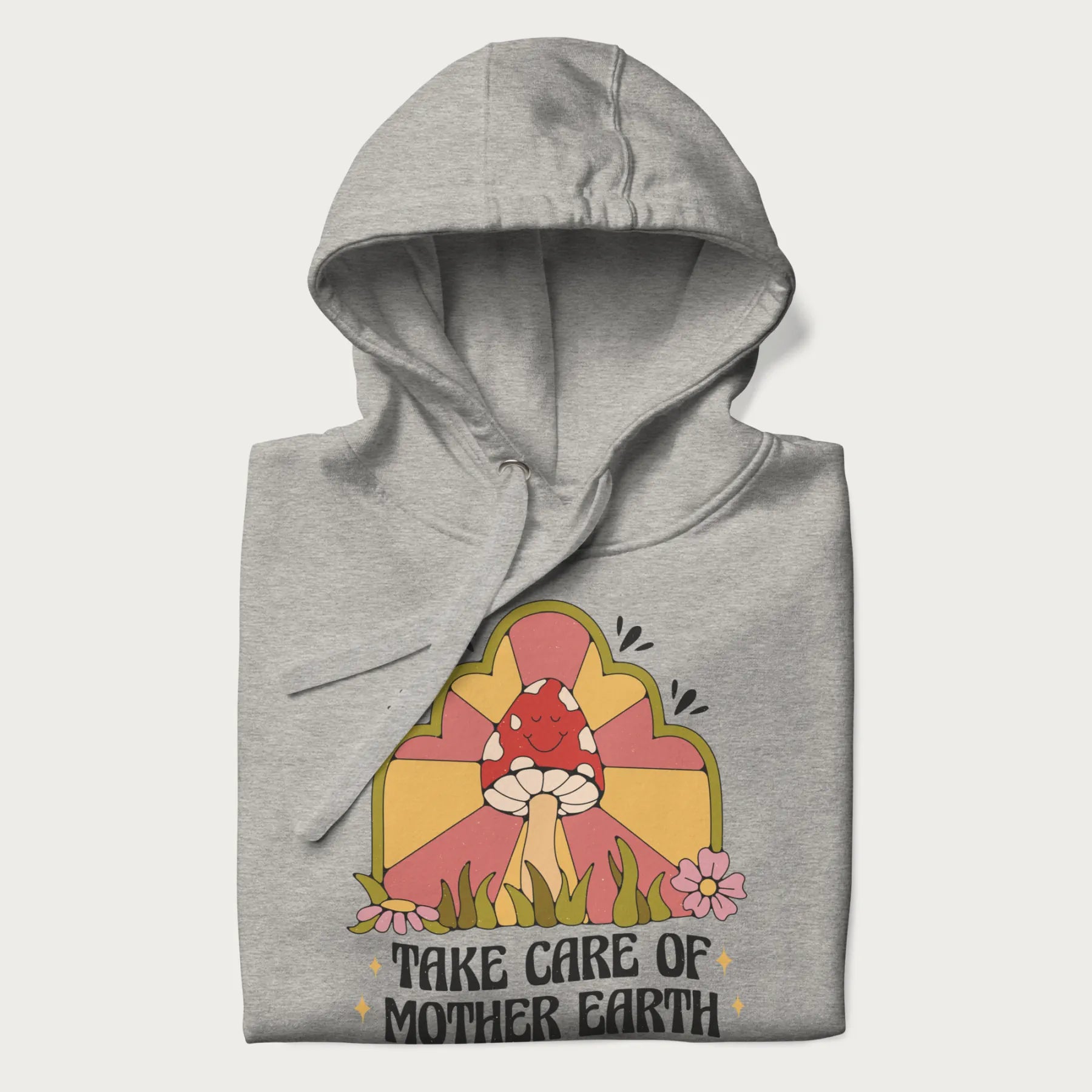 Folded light grey hoodie with a graphic of a happy red mushroom, sunburst background, and the text 'Take Care of Mother Earth'.