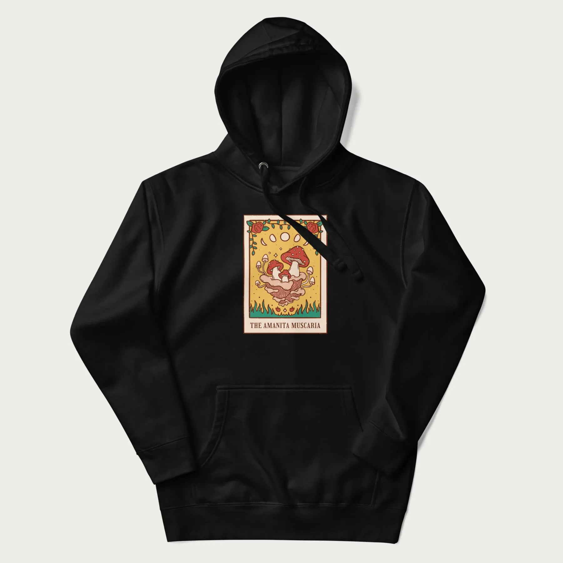 Black hoodie featuring a graphic of Amanita Muscaria mushrooms with floral accents and moon phases, resembling a tarot card.