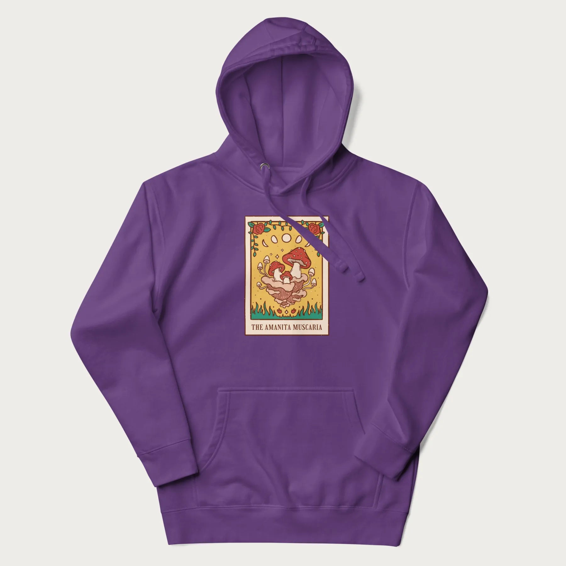 Purple hoodie featuring a graphic of Amanita Muscaria mushrooms with floral accents and moon phases, resembling a tarot card.