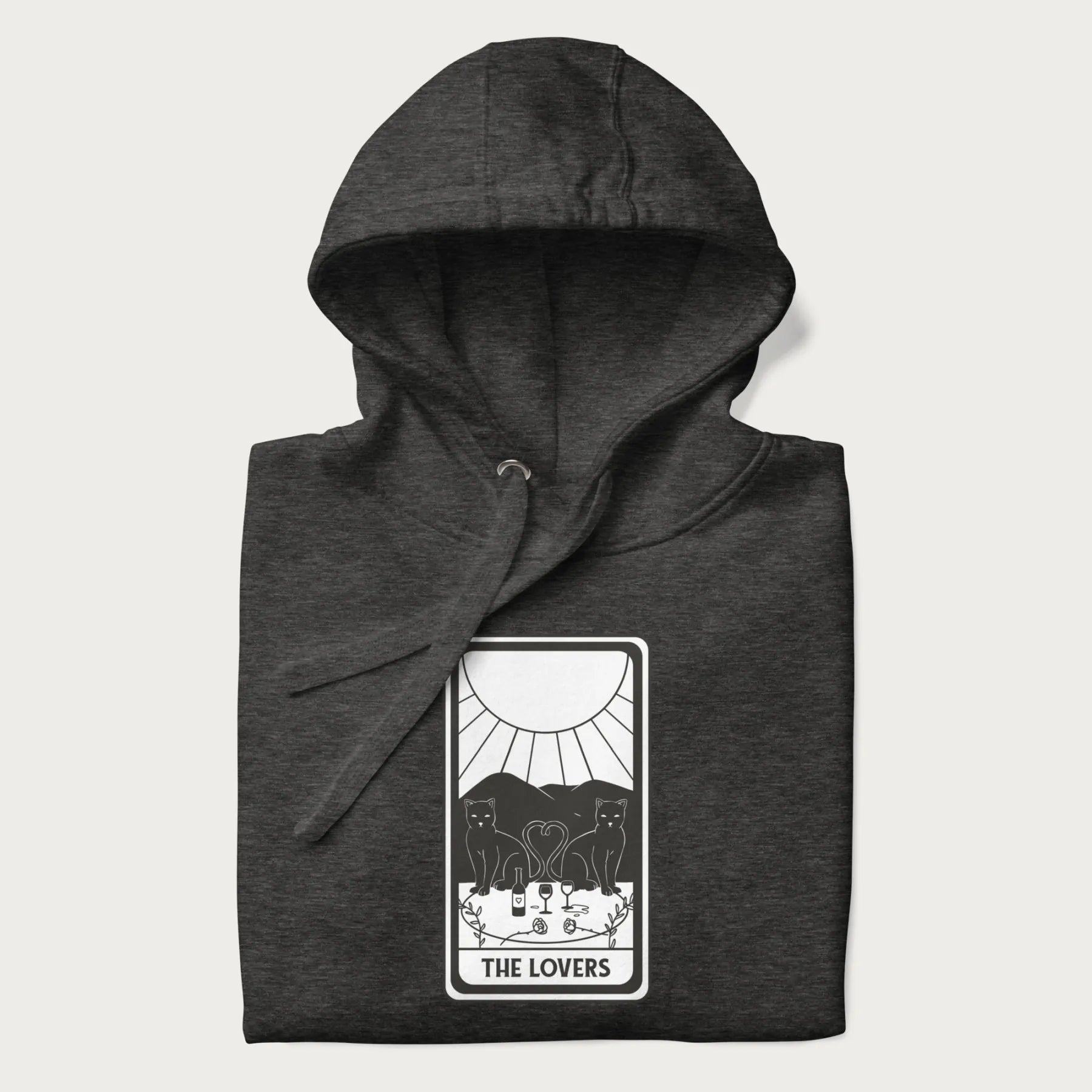 Folded dark grey hoodie with a 'The Lovers' tarot card graphic of two cats with intertwined tails forming a heart, wine, and roses.
