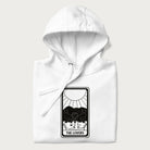 Folded white hoodie with a 'The Lovers' tarot card graphic of two cats with intertwined tails forming a heart, wine, and roses.