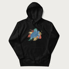 Black hoodie with a vibrant graphic of a blue sea turtle and colorful tropical leaves.