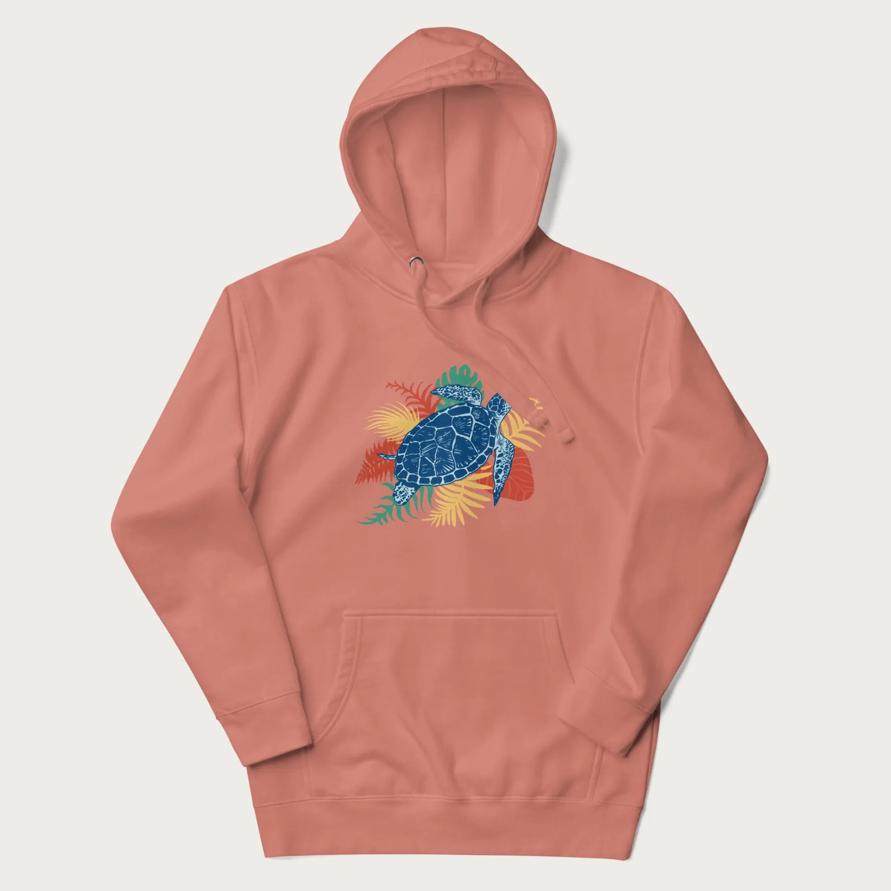 Light pink hoodie with a vibrant graphic of a blue sea turtle and colorful tropical leaves.