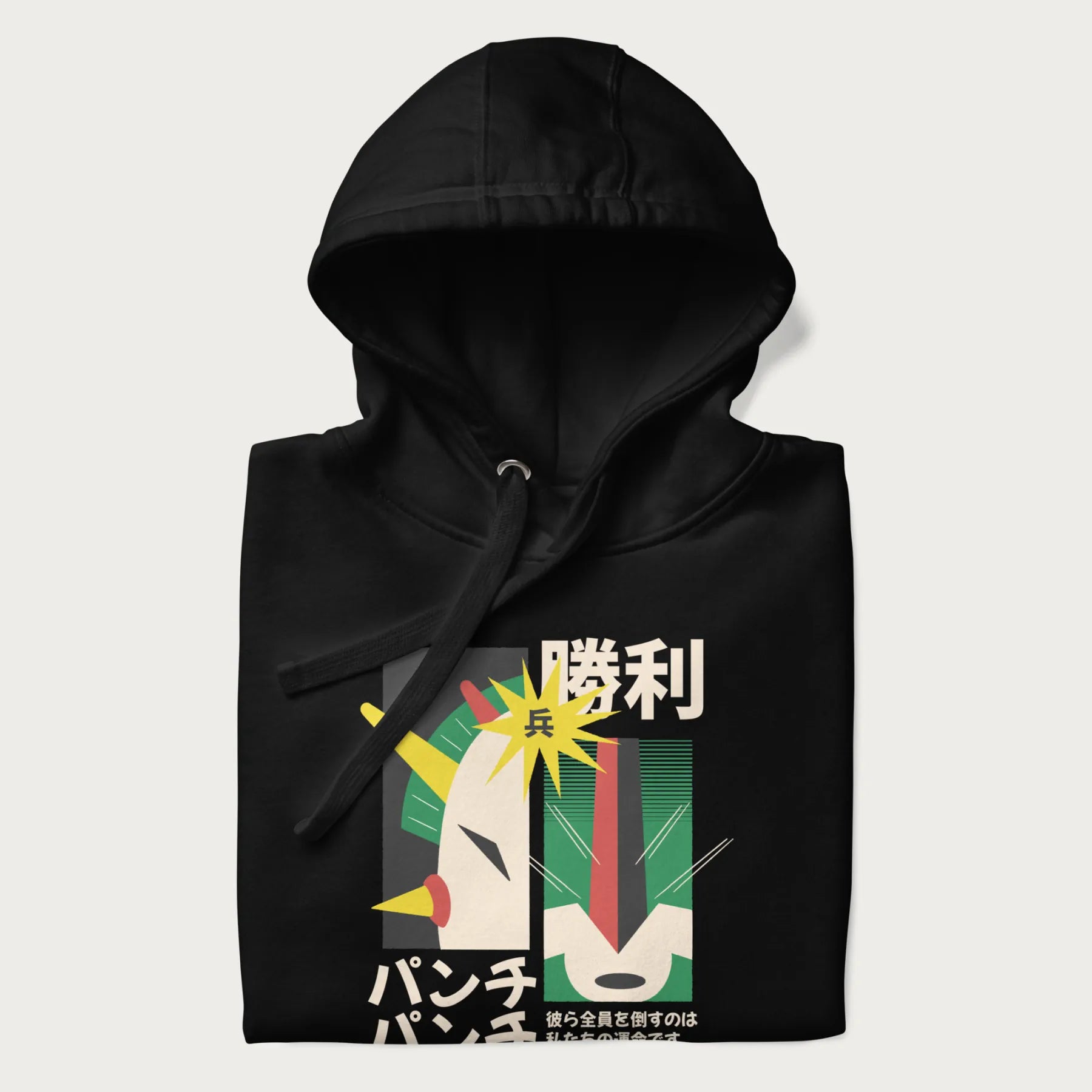 Folded black hoodie with Japanese text and a graphic of a retro-futuristic robot fighter, inspired by Japanese mecha art.