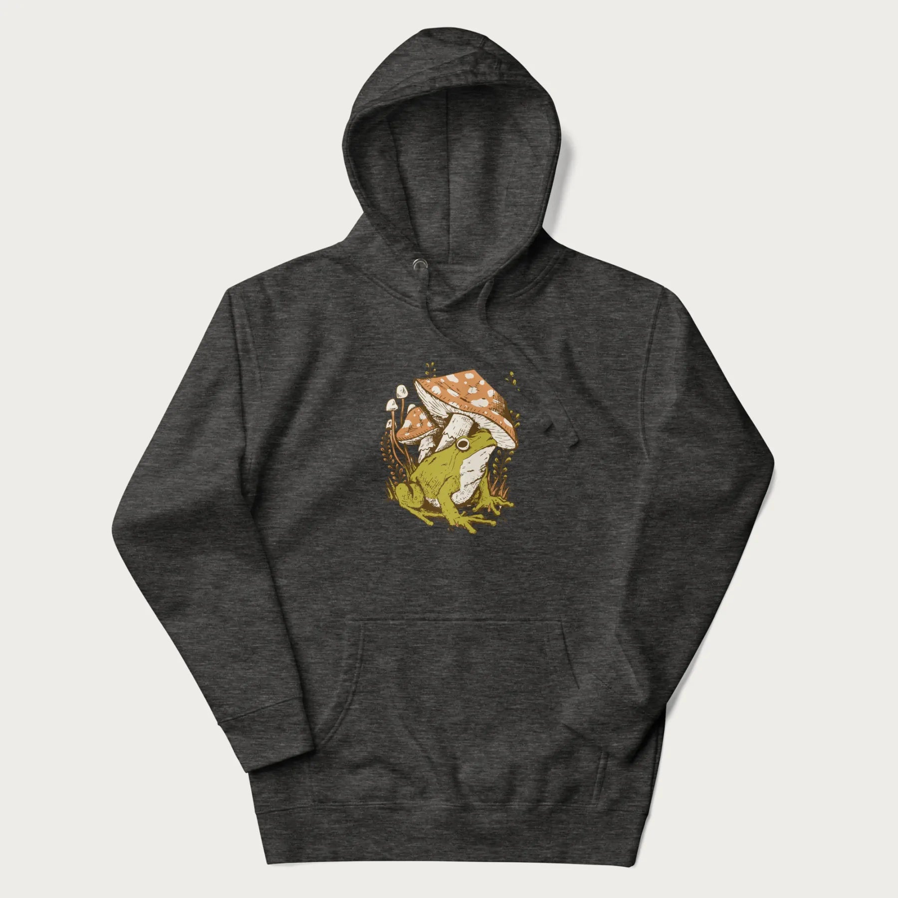 Dark grey hoodie with cottagecore graphic of a frog under mushrooms with foliage in the background.