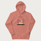 Light pink hoodie with graphic of mystical mushrooms with an all-seeing eye and the text 'Wisdom Begins in Wonder' framed by a rainbow arch.