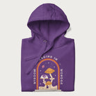 Folded purple hoodie with graphic of mystical mushrooms with an all-seeing eye and the text 'Wisdom Begins in Wonder' framed by a rainbow arch.