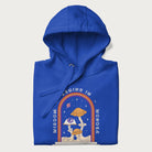 Folded royal blue hoodie with graphic of mystical mushrooms with an all-seeing eye and the text 'Wisdom Begins in Wonder' framed by a rainbow arch.