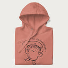 Folded light pink hoodie with a cute champignon mushroom graphic and the text "You're a Real Champignon!"