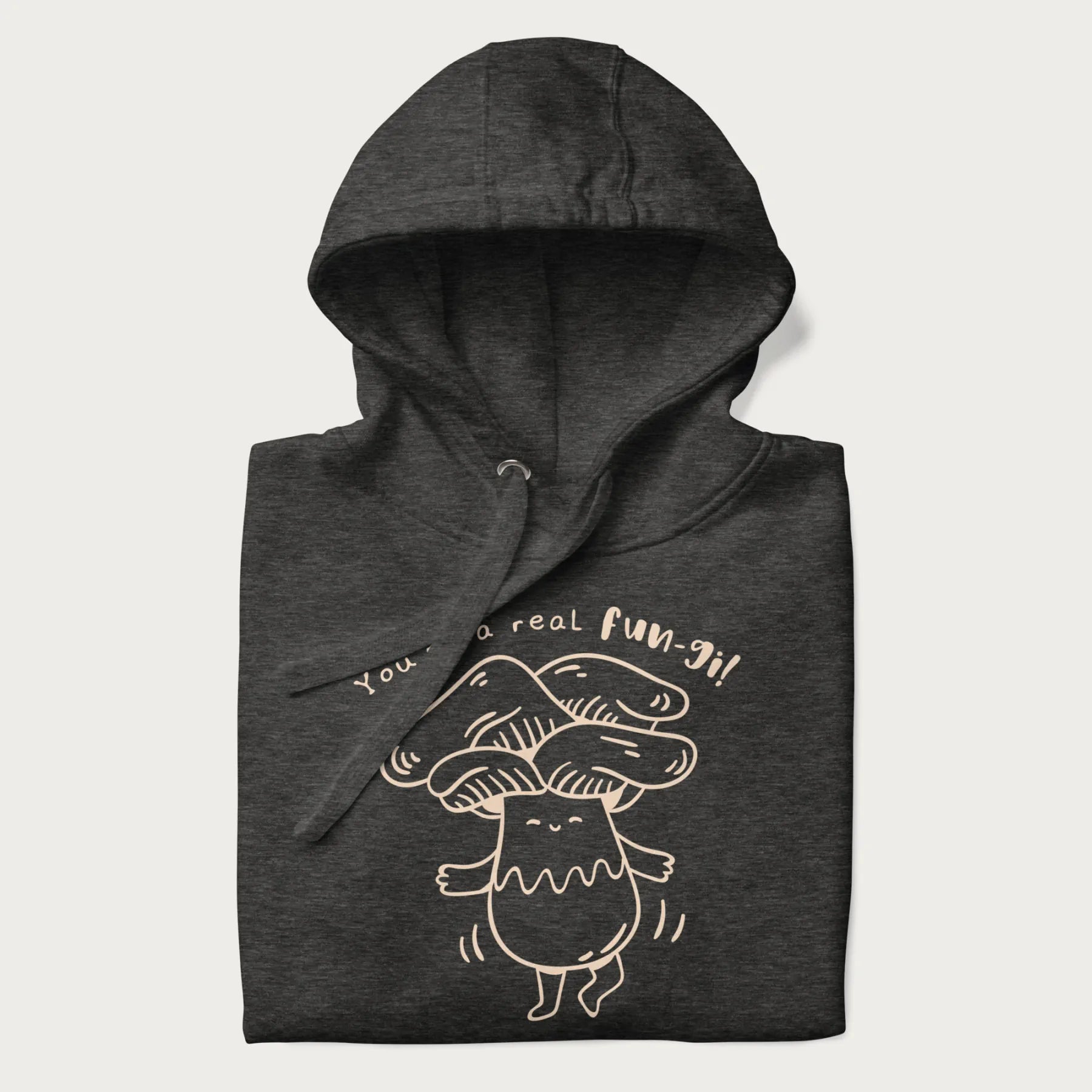 Folded dark grey hoodie with graphic of a cute mushroom joyfully dancing with the text "You're a Real Fun-gi!"