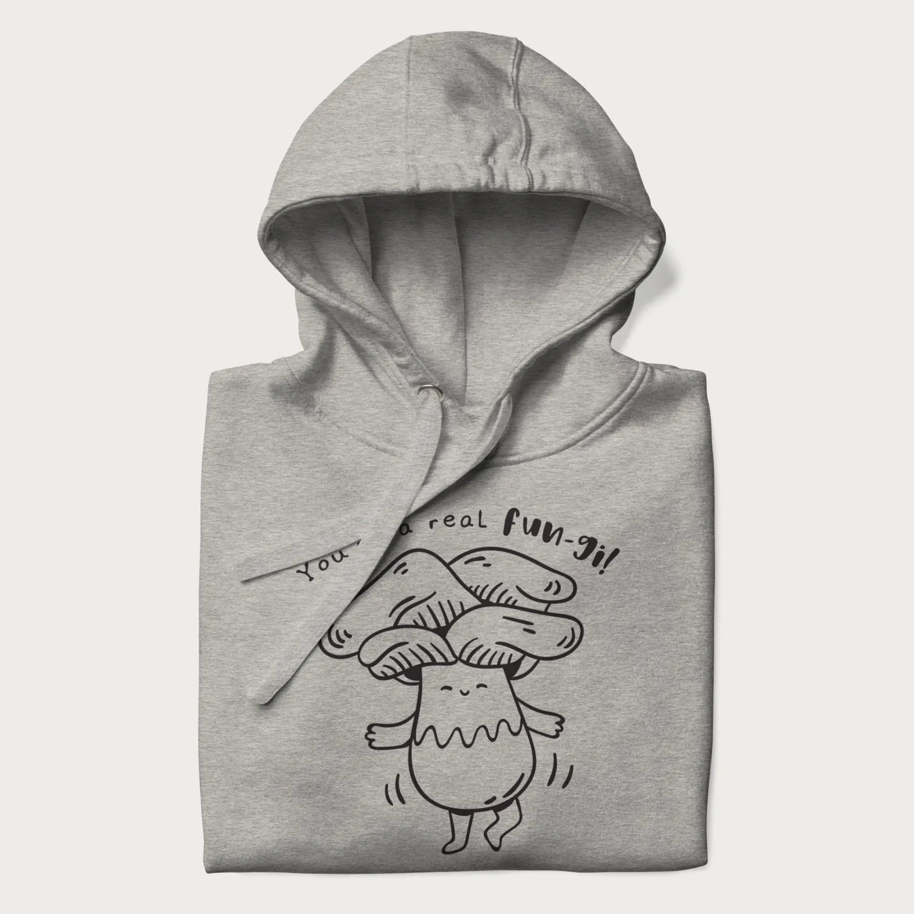 Folded light grey hoodie with graphic of a cute mushroom joyfully dancing with the text "You're a Real Fun-gi!"