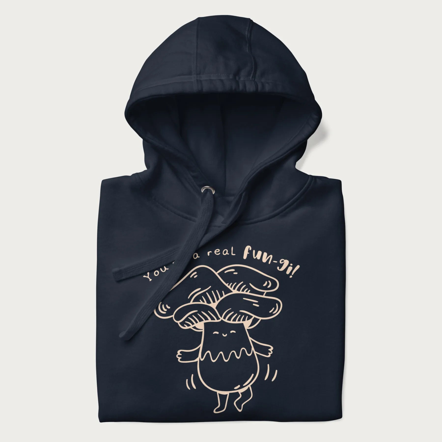 Folded navy blue hoodie with graphic of a cute mushroom joyfully dancing with the text "You're a Real Fun-gi!"