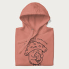 Folded light pink hoodie with a cute mushroom graphic and the text "You're FUNGING Awesome!"