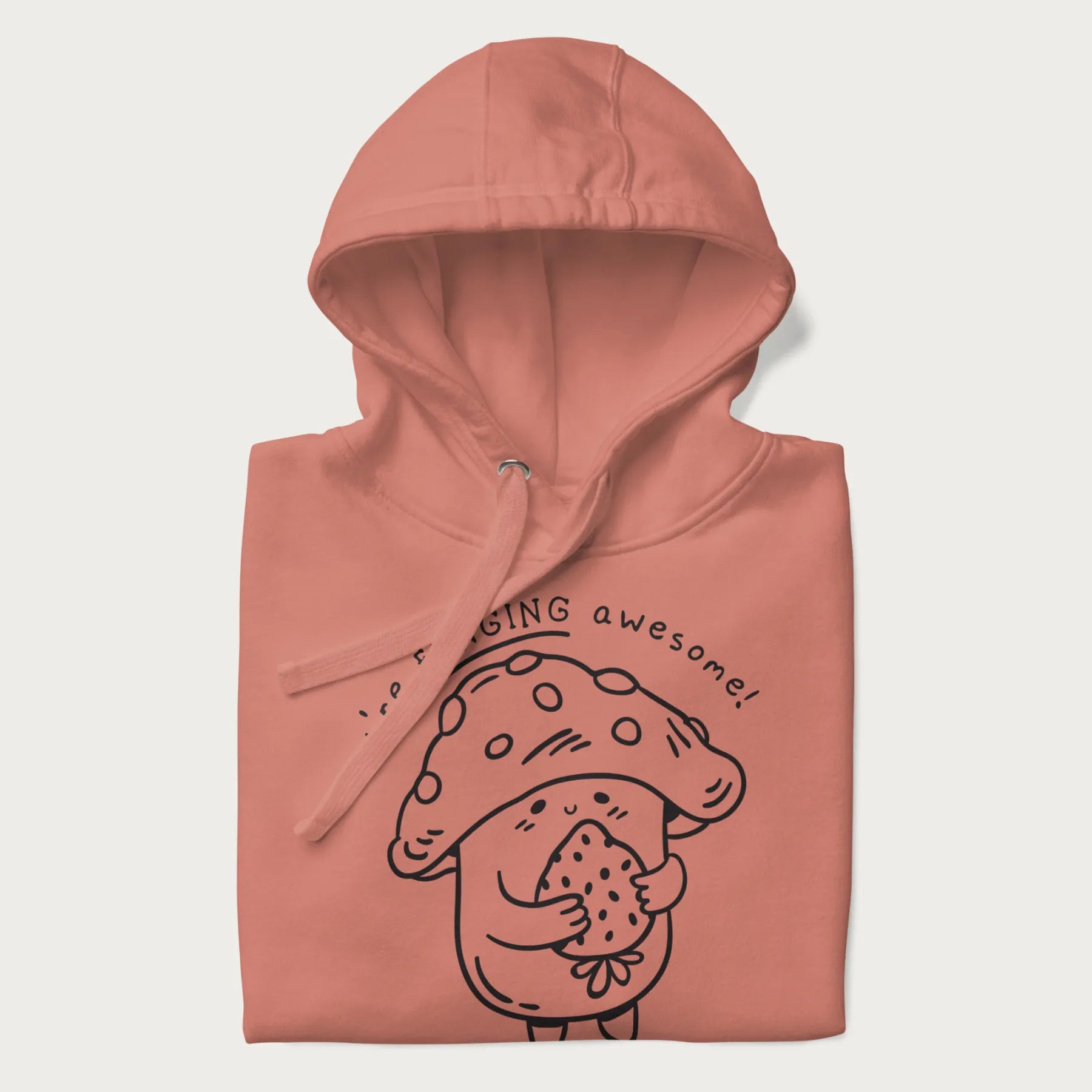 Folded light pink hoodie with a cute mushroom graphic and the text "You're FUNGING Awesome!"