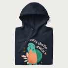 Folded navy blue hoodie with a cute turtle graphic and the text 'You're Shella Cute' above.