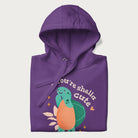 Folded purple hoodie with a cute turtle graphic and the text 'You're Shella Cute' above.