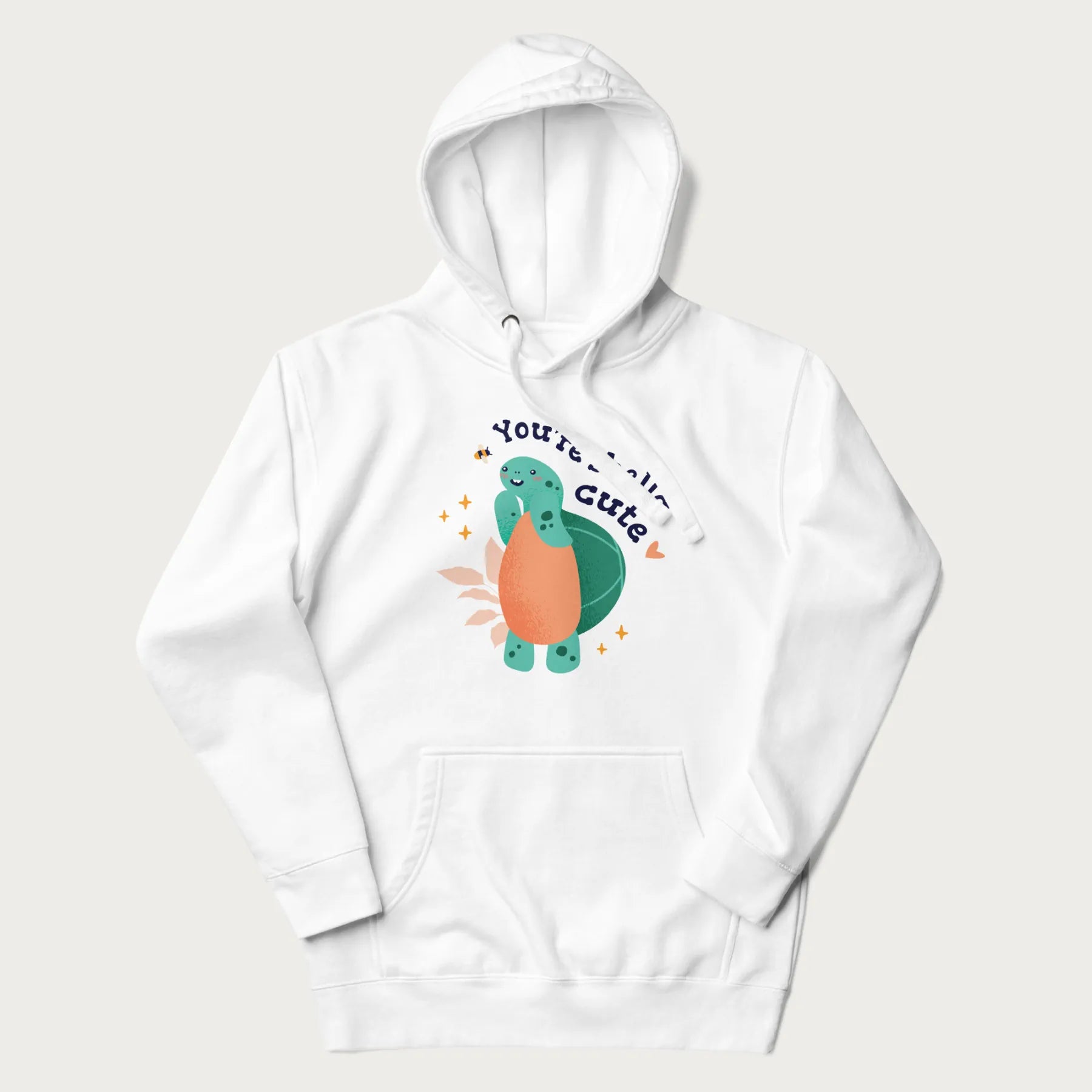 White hoodie with a cute turtle graphic and the text 'You're Shella Cute' above.