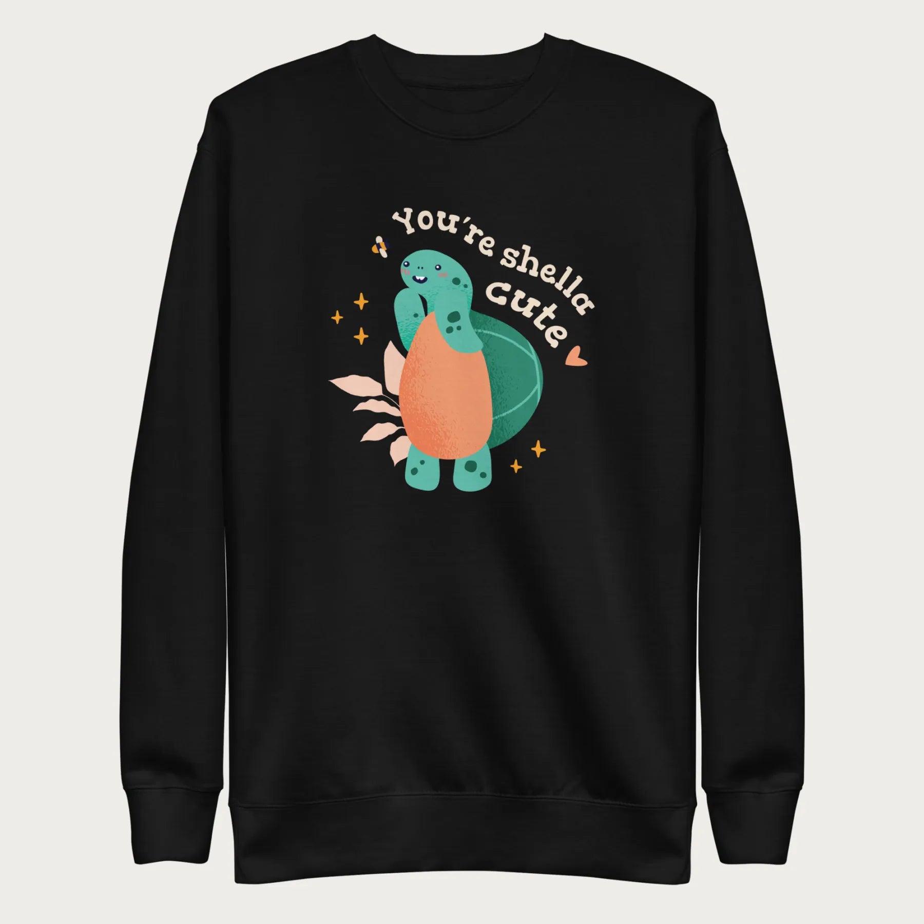 Black sweatshirt with a cute graphic of a smiling turtle and bee with the phrase 'You're Shella Cute.'